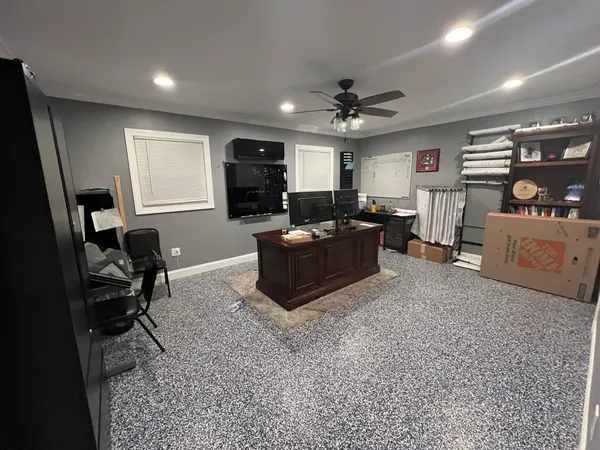 a living room with furniture a flat screen tv and a window