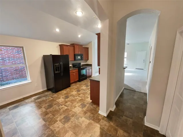a view of a hallway with wooden floor and furniture