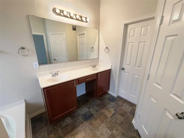 a bathroom with a sink a mirror and a vanity