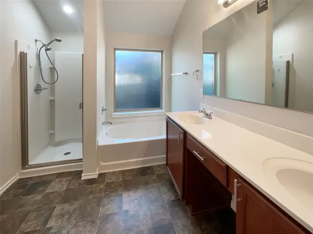 a bathroom with a tub sink and mirror