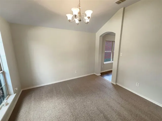 a view of a chandelier fan and window