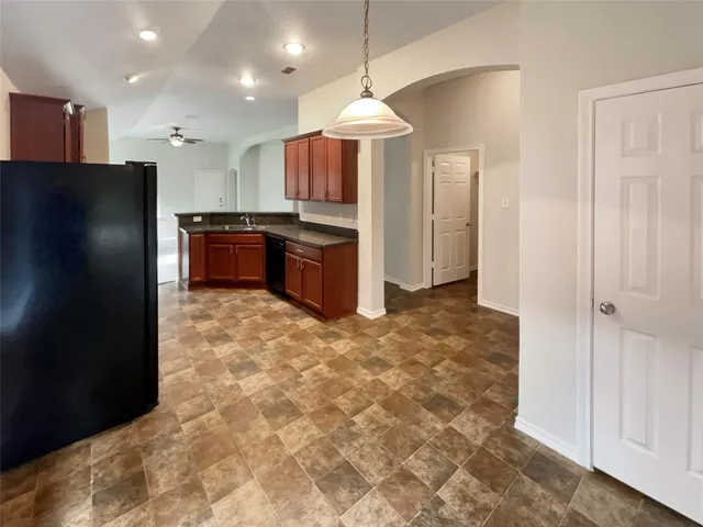 a large kitchen with a refrigerator and a stove
