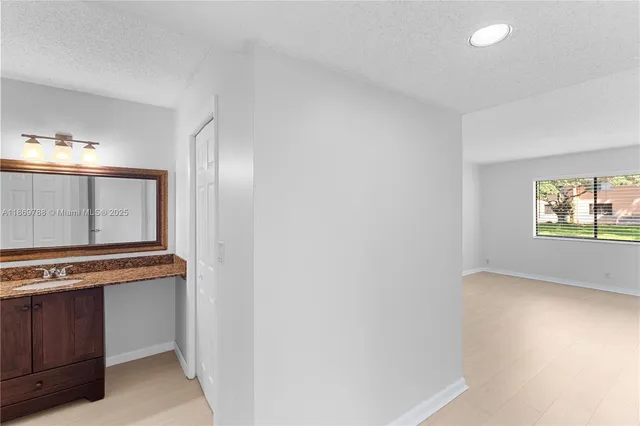a view of a kitchen with wooden floor and cabinet