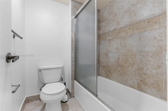 a bathroom with a toilet and shower
