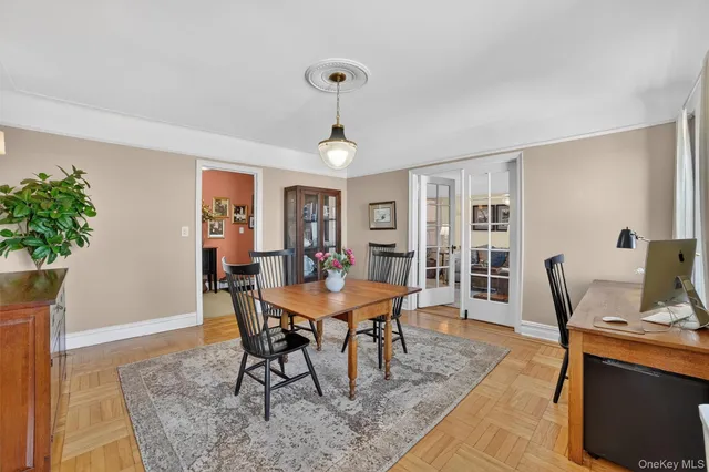 a view of a dining room with furniture and a potted plant