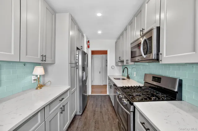 a kitchen with stainless steel appliances granite countertop a stove and a refrigerator