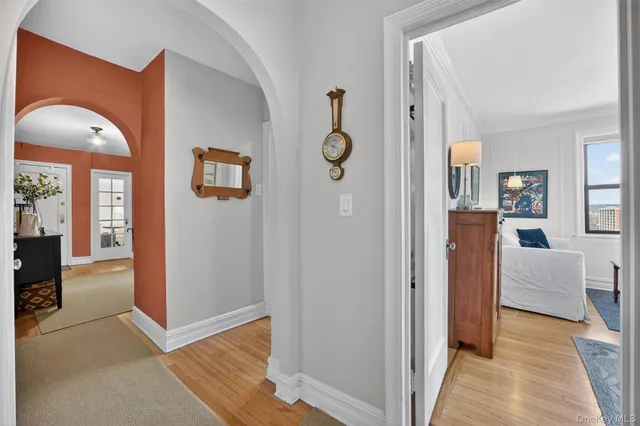 wooden floor with white walls and windows