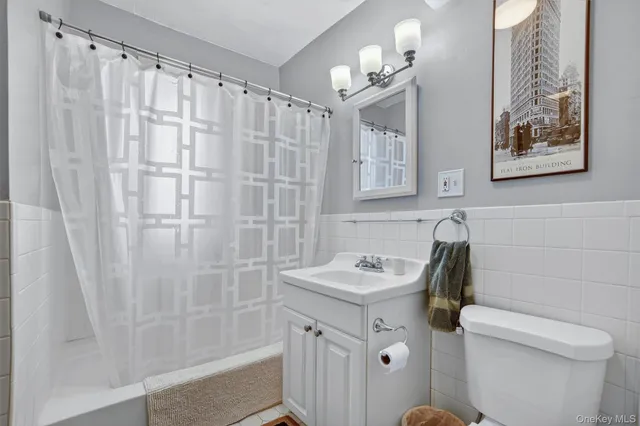 a bathroom with a sink a toilet and shower curtain