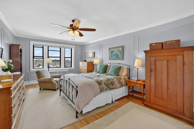 a bedroom with a bed couch and window