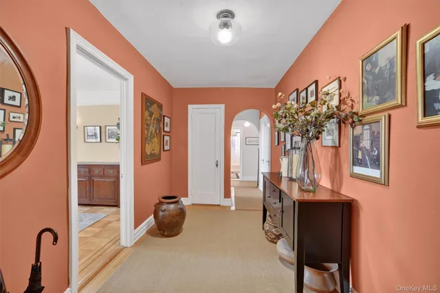 a view of hall way with furniture and chandelier