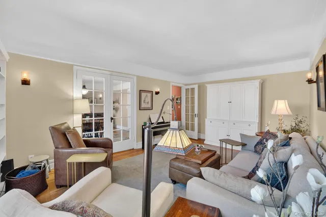 a living room with furniture a lamp and a window
