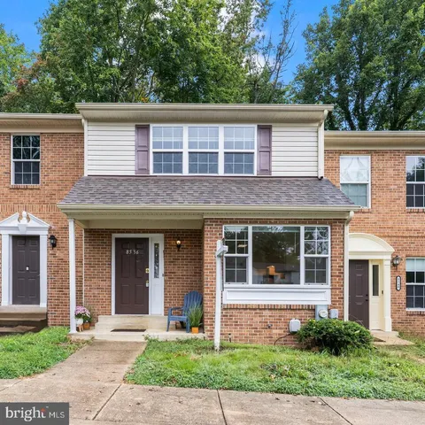 a brick house with a large windows