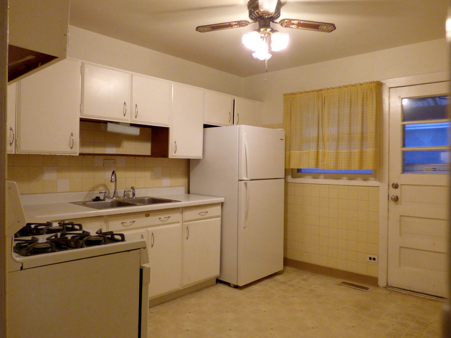 6830 Valley View Road Hanover Park, IL 60133 - Photo 3 of 8 a kitchen with a refrigerator a sink and cabinets