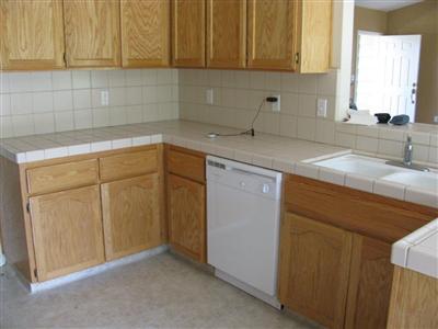 6496 Elwood Road Sanger, CA 93657 - Photo 9 of 26 VIEW OF KITCHEN WORK AREA AND BREAKFAST BAR
