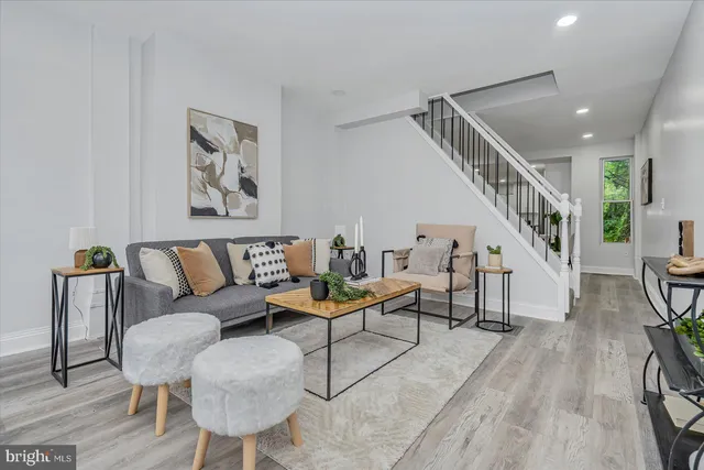 a living room with furniture and a wooden floor
