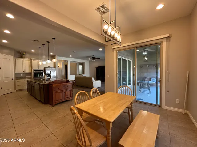 a large kitchen with a table and chairs
