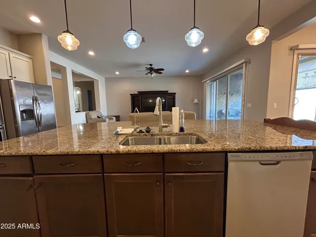 a kitchen with granite countertop white cabinets and stainless steel appliances