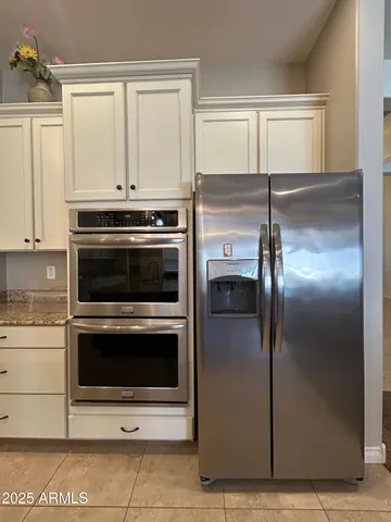 a kitchen with kitchen island a sink stainless steel appliances and cabinets