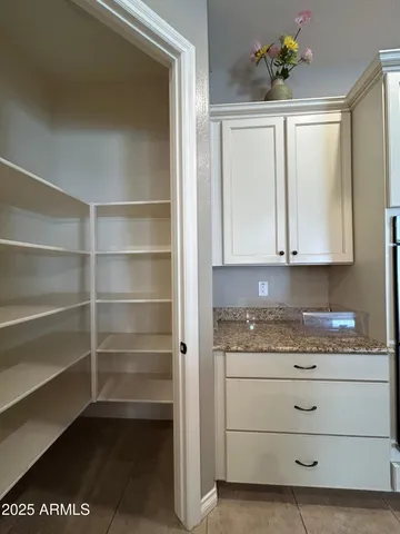 a large kitchen with kitchen island a counter space a sink and living room view