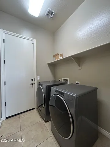 a utility room with washing machine