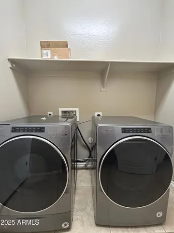 an empty room with windows chandelier fan and windows