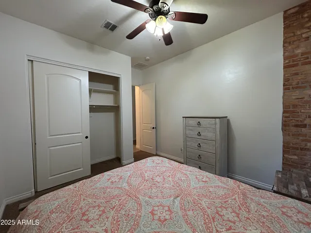 a view of a livingroom with a ceiling fan and window