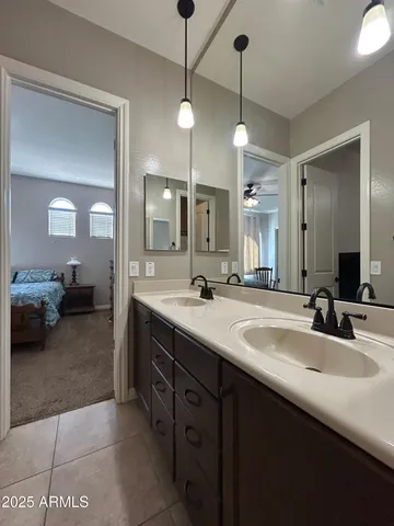 an empty room with windows and chandelier fan