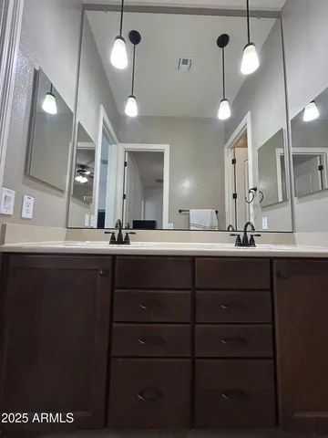 a bedroom with a bed and a ceiling fan