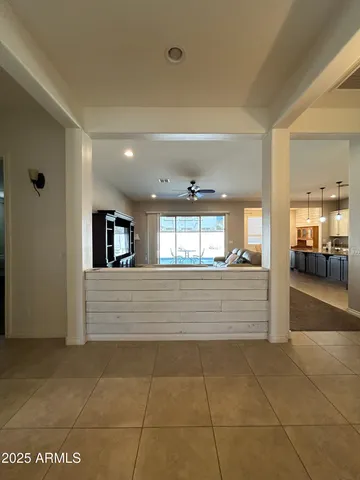 a view of hallway with stairs and wooden floor