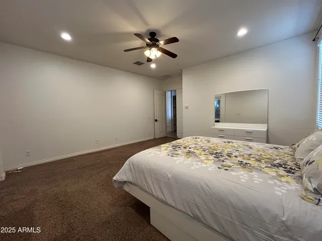 a large kitchen with a large center island wooden cabinets and stainless steel appliances
