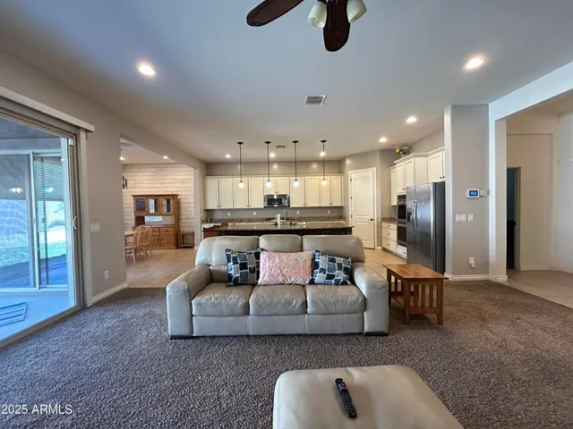 a living room with furniture and kitchen view