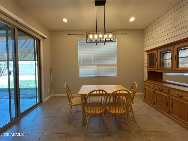 a view of a dining room with furniture wooden floor and chandelier