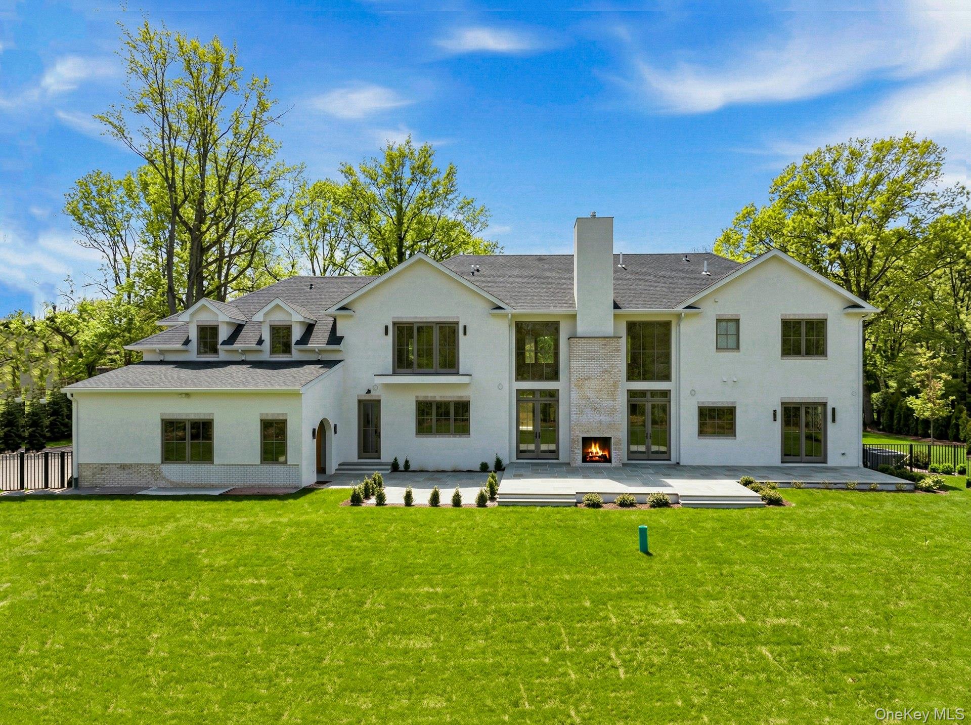25 West Creek Farms Road Sands Point, NY 11050 - Photo 36 of 39 a front view of building with yard and outdoor seating