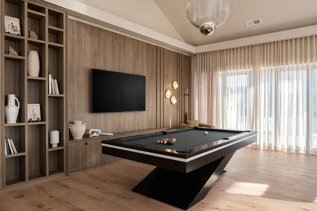 a living room with furniture and a floor to ceiling window