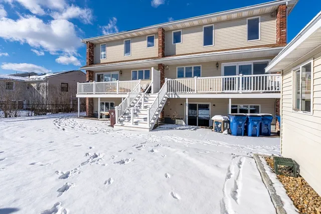 a view of a house with a yard covered in snow