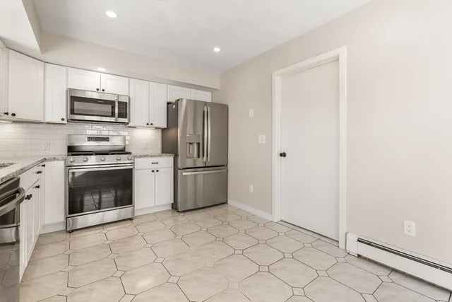 a kitchen with stainless steel appliances a stove a sink and a refrigerator
