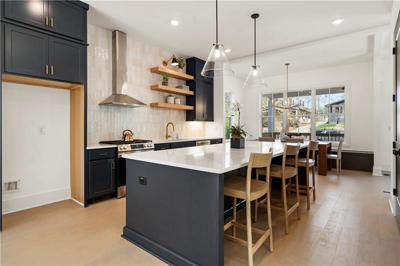 1901 Browns Mill Road Southeast Atlanta, GA 30315 - Photo 13 of 42 a kitchen with stainless steel appliances granite countertop a sink a stove a refrigerator and island with wooden floor