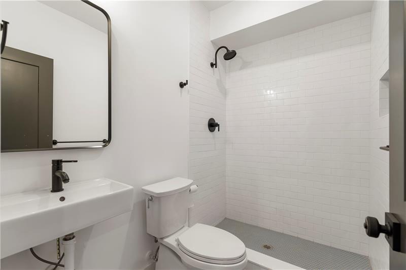 1901 Browns Mill Road Southeast Atlanta, GA 30315 - Photo 38 of 42 a bathroom with a sink a toilet and shower