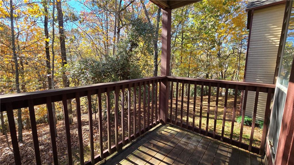 1313 Red Deer Way, Unit 253 Alpharetta, GA 30022 - Photo 1 of 1 a view of a balcony with wooden fence and floor