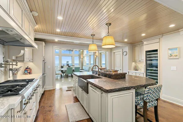 a dining room with furniture a floor to ceiling window and outdoor view