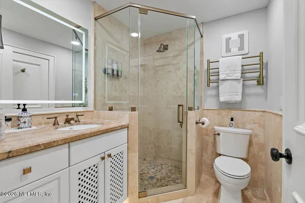 a picture of a room with a white wall and has a large window