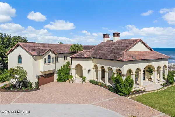 an aerial view of residential houses with outdoor space and lake view