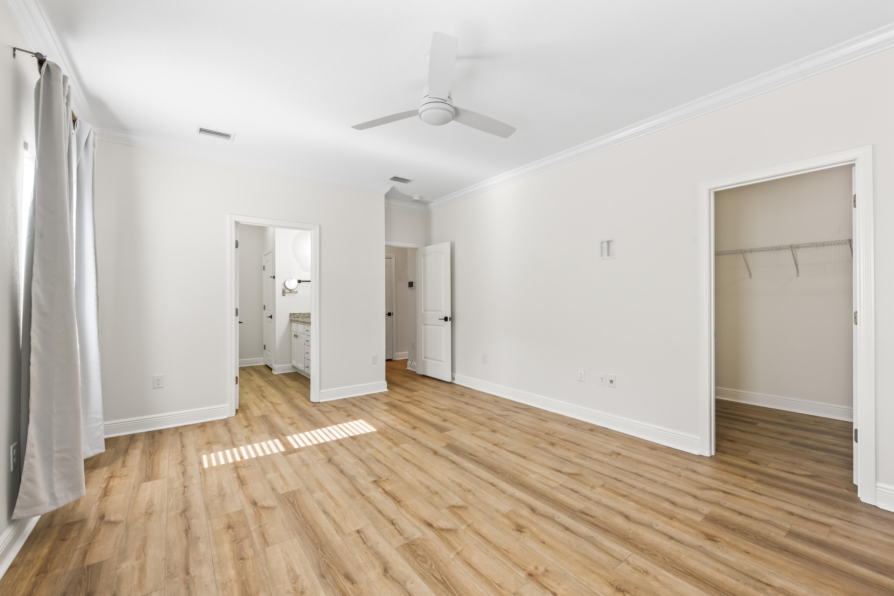 369 Wayne Trail Santa Rosa Beach, FL 32459 - Photo 16 of 47 an empty room with wooden floor and a ceiling fan