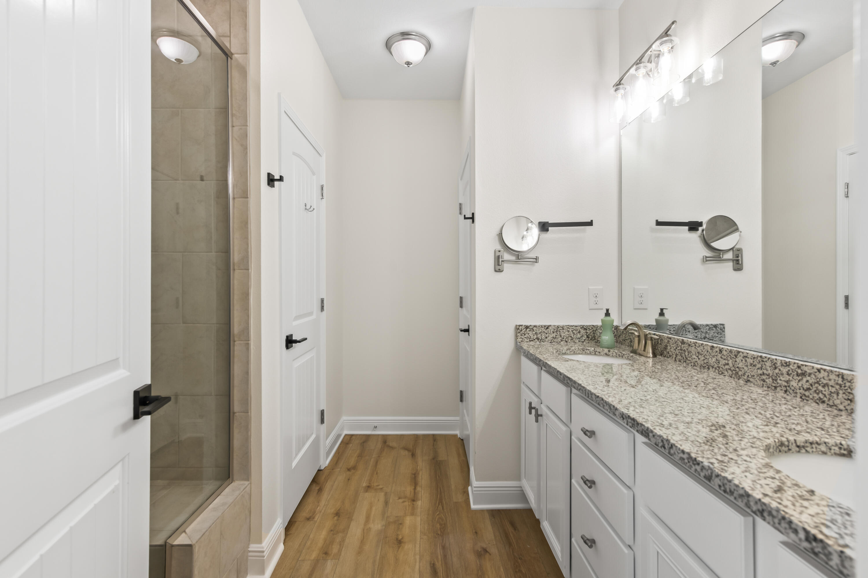 369 Wayne Trail Santa Rosa Beach, FL 32459 - Photo 19 of 47 a spacious bathroom with a granite countertop sink and a mirror