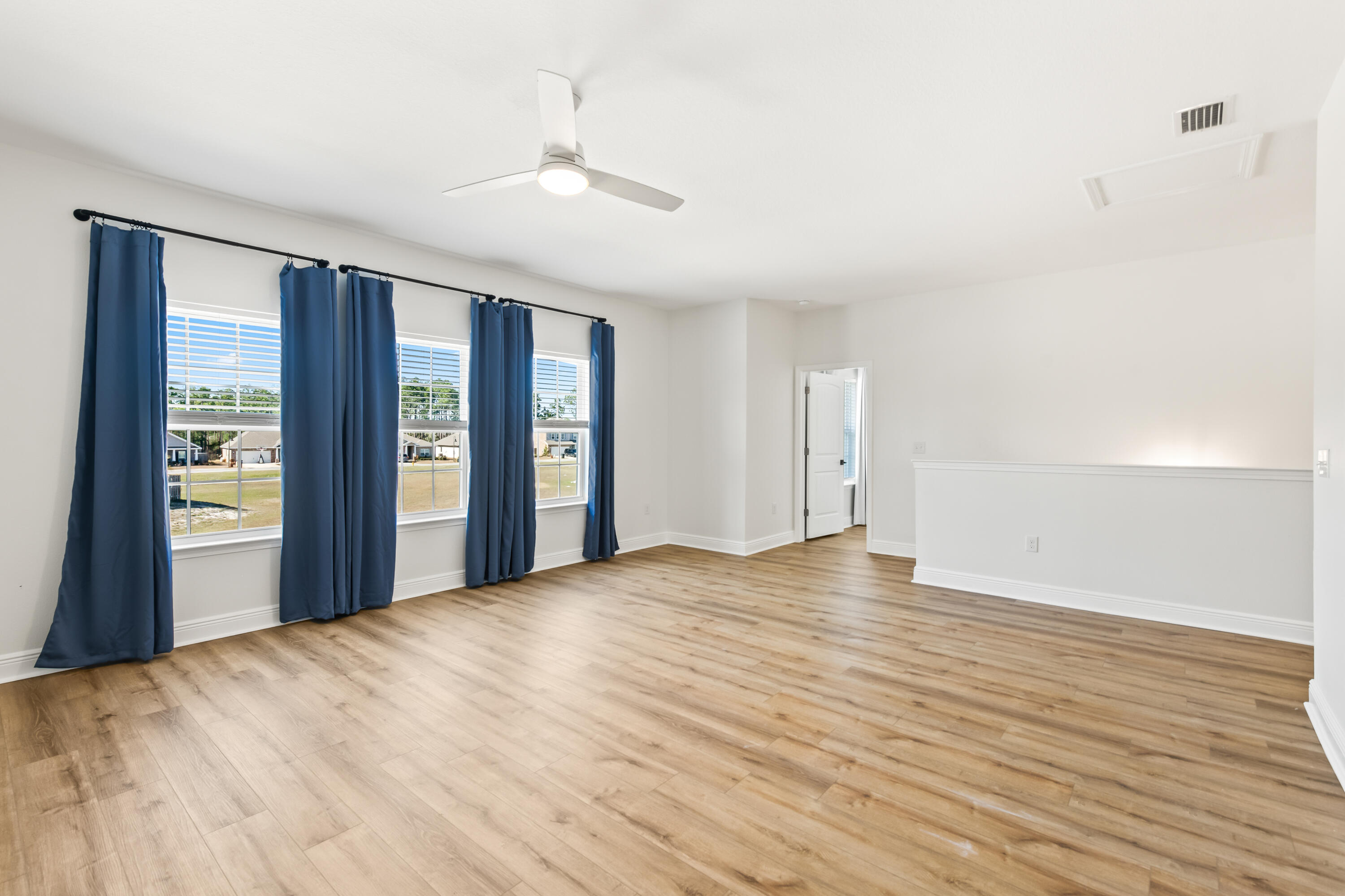 369 Wayne Trail Santa Rosa Beach, FL 32459 - Photo 25 of 47 a view of an empty room with a window and wooden floor