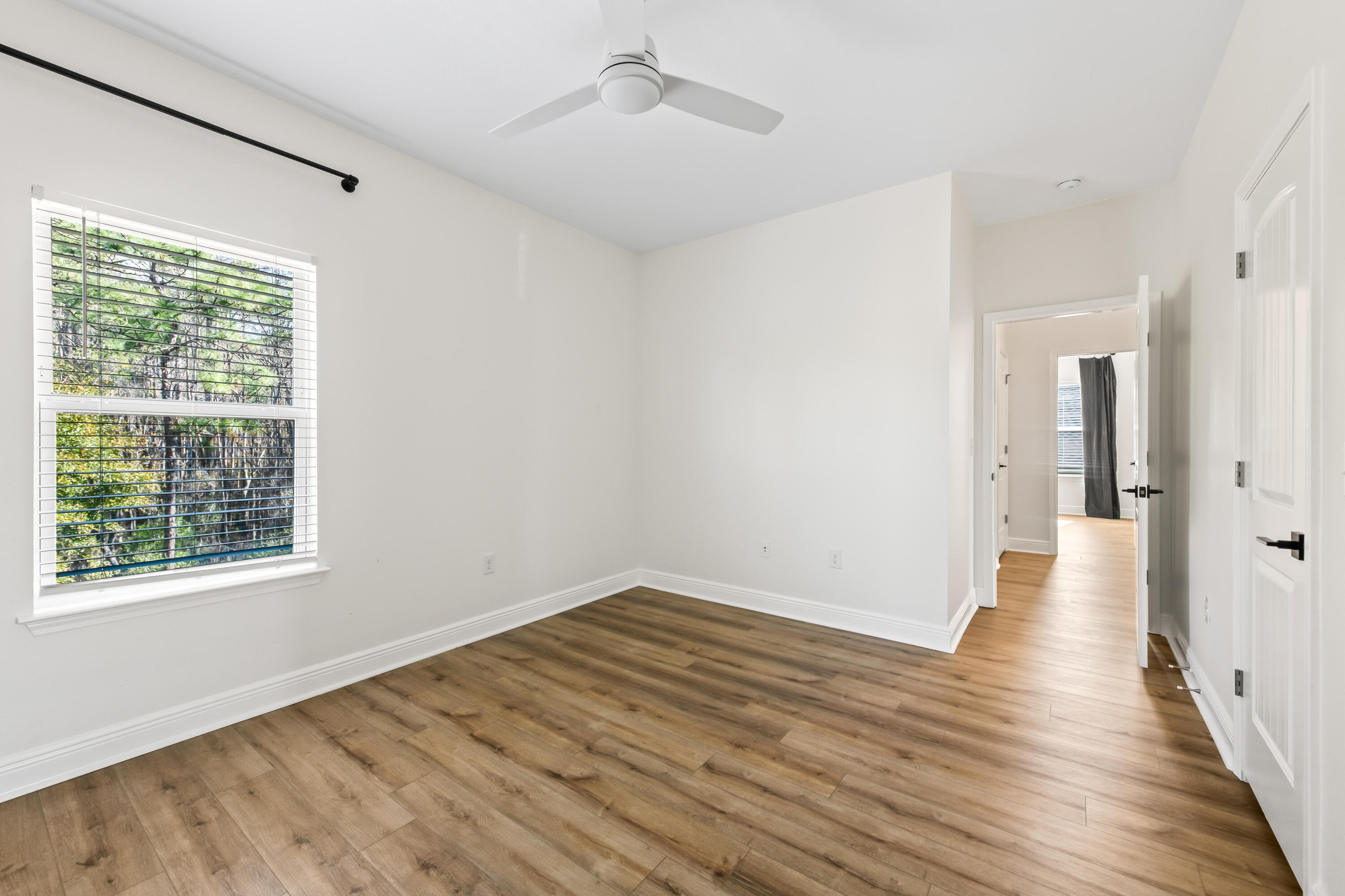 369 Wayne Trail Santa Rosa Beach, FL 32459 - Photo 31 of 47 a view of an empty room with wooden floor and a window