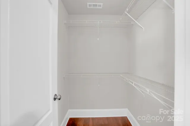 a bathroom with a granite countertop sink toilet a mirror and a tub