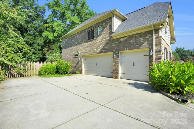 view of a house with a yard and garage
