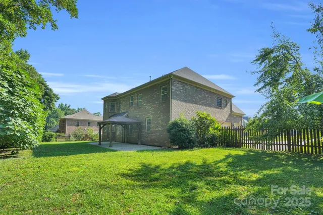 a view of a yard with a house in the background