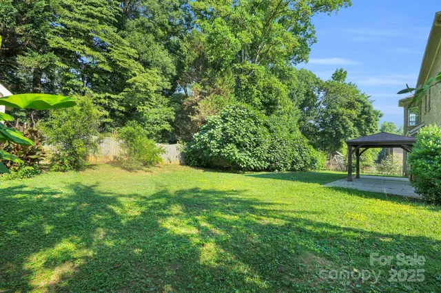 an aerial view of a house with a garden and swimming pool